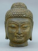 A stone Buddha head. 26 cm high.