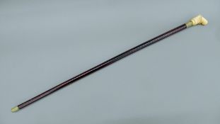 A walking stick, the bone handle formed as a gentleman. 91 cm high.
