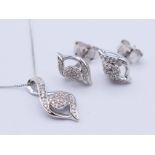 A 9 ct white gold diamond-set pendant necklace and a pair of earrings. The pendant 1.5 cm high. 2.