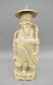 A painted wooden carving of a Chinese fisherman. 54 cm high.