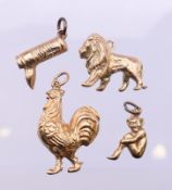 Four 9 ct gold charms. The cockerel 2.5 cm high. 9.4 grammes total weight.