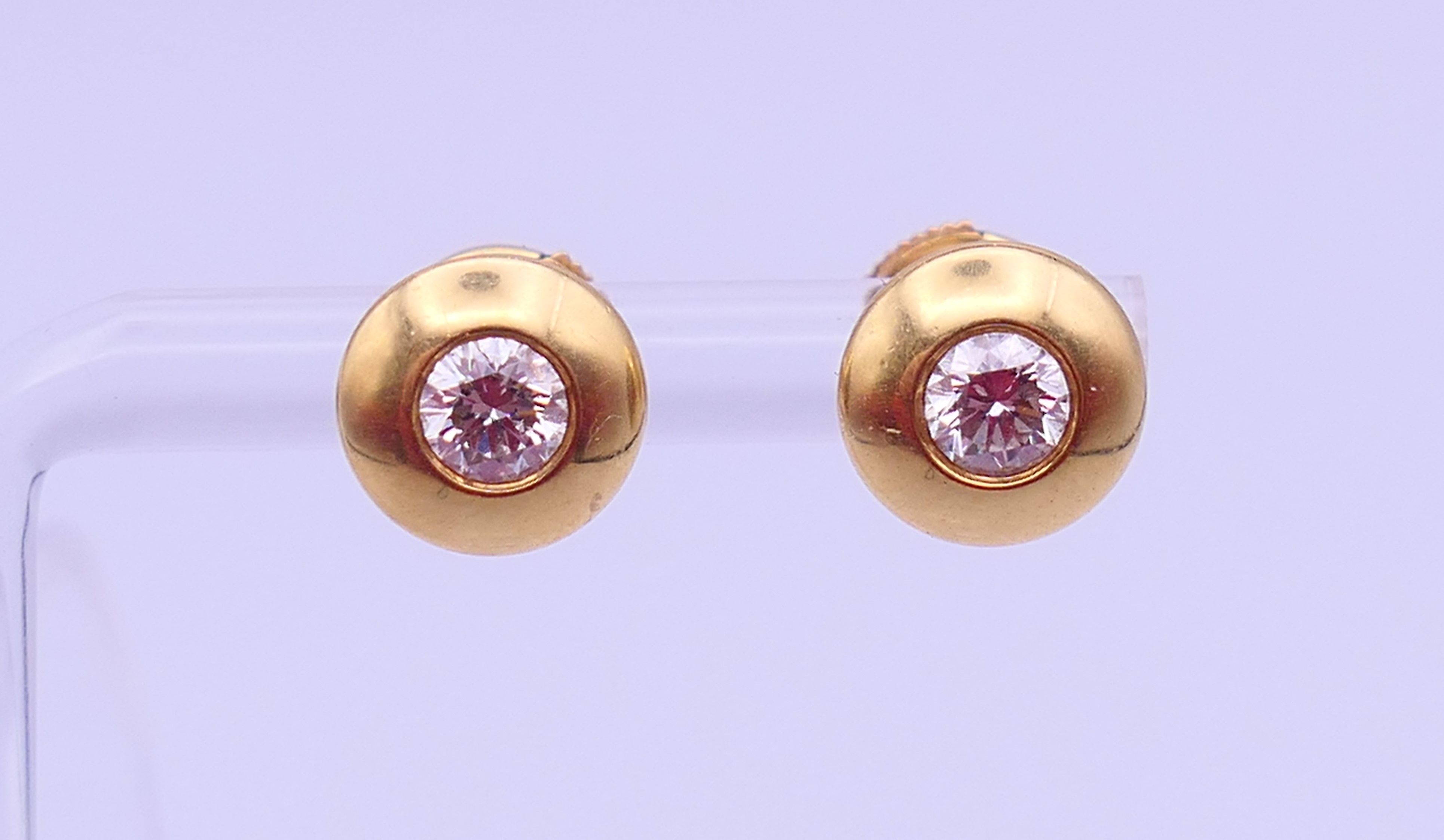 A pair of 18 ct gold and diamond ear studs, each stone approximately 0.25 ct. Each 8 mm diameter. 3.