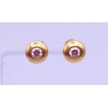 A pair of 18 ct gold and diamond ear studs, each stone approximately 0.25 ct. Each 8 mm diameter. 3.