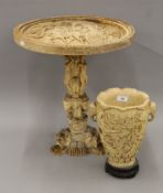 A resin table and vase, each with Asian decoration. The table 49 cm high.