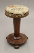 A Victorian tapestry-topped mahogany piano stool. 49 cm high.