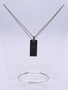 A silver ingot silver jubilee (1952-1977) pendant on a silver chain and a 14 ct white gold identity