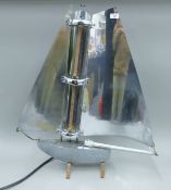 A classic 1930's design Bunting & Co electric fire formed as a yacht with chrome sails. 77 cm high.