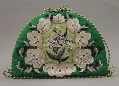 A vintage beadwork tea cosy. 35 cm long.