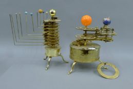 Two brass oval orreries. The larger 38 cm high.