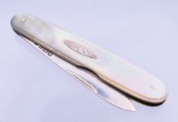 A silver and mother-of-pearl fruit knife. 7.5 cm long closed.