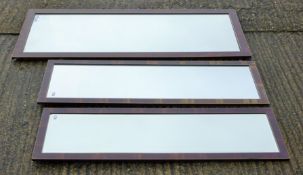 A set of three early 20th century mahogany-framed wall mirrors of varying sizes.