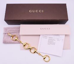 An 18 ct gold Gucci horsebit bracelet in maker's fitted box with original invoice and papers.