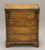 A 20th century 18th century-style walnut bachelor's chest. 61 cm wide.