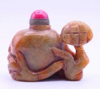 A russet jade snuff bottle and stopper. 6 cm high, 7 cm long.