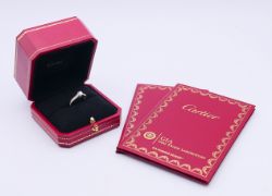 A boxed Cartier platinum and diamond ring (0.