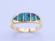 An Idaho Opal and Gem Company 14K gold and black opal ring. Ring size P. 3.9 grammes total weight.