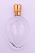 An 18 ct gold topped scent bottle. 9 cm high.