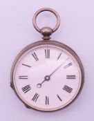 A silver case pedometer. 4.5 cm diameter.