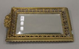 A Victorian brass strutt mirror surmounted with cherubs. 29 x 40 cm.