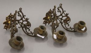 A pair of Victorian brass double candle sconces. Each 22 cm long.