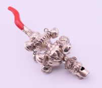 A silver baby's rattle and whistle. 14 cm high.