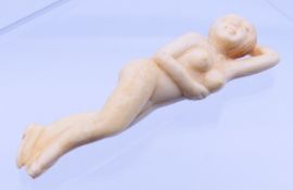 A carved bone doctor's figure. 9.25 cm long.