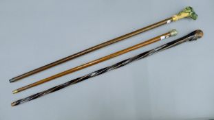 Three various walking sticks, one with a silver-plated knop,
