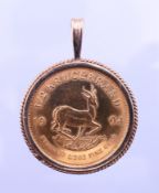A 1994 half Krugerrand gold coin in an 9 ct gold pendant mount. 3 cm diameter. 20.