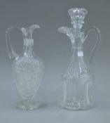 A Victorian glass claret jug and stopper and another cut glass claret jug. The former 33 cm high.