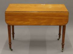 A Victorian satinwood Pembroke table. 106 cm long.