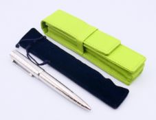 A pen stamped Rolex in a lime green case. 13.5 cm long.