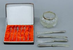 A silver-topped cut glass jar, four silver-handled butter knives and a boxed set of teaspoons.