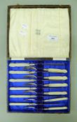 A cased set of mother-of-pearl handled silver dessert knives and forks. The case 23 cm wide.