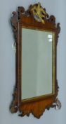 A 19th century gilt heightened mahogany-framed wall glass. 48 x 80 cm.