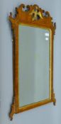 A 19th century gilt heightened walnut-framed wall glass. 50 x 89 cm.