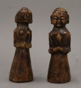 A pair of African Tribal carved wooden figures depicting a man and a woman. Each 16 cm high.