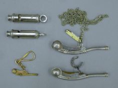 Three boatswain's whistles, a small penknife and two police whistles. The largest 11.5 cm long.
