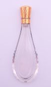 An 18 ct gold topped scent bottle. 10 cm high.