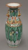 A late 19th/early 20th century Chinese porcelain vase with pak choi decoration and red