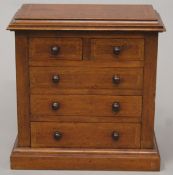 An Edwardian inlaid mahogany miniature chest of drawers. 33.5 cm wide x 36 cm high.