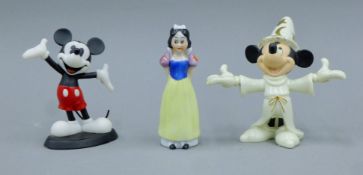 Two Disney figures of Mickey Mouse and a porcelain Snow White toothbrush holder.