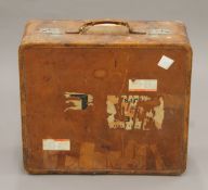 A vintage leather suitcase with some old travel labels. 55 cm wide.