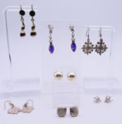 Seven pairs of silver earrings. Amethyst drop earrings 3.5 cm high.