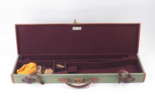 A good Brady canvas and leather gun case, with claret baize lined fitted interior for 28 ins barrels