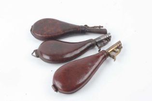 Three various leather shot flasks, one brass mounted, two iron mounted, two with suspension rings