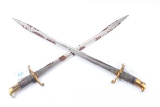 Two British Lancaster Sword Bayonets with 24 ins pipe backed blades, brass cross guards and pommels,