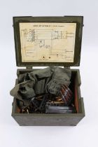 Wooden military supply unit case containing various once-fired brass, .303 clips in sling, and three
