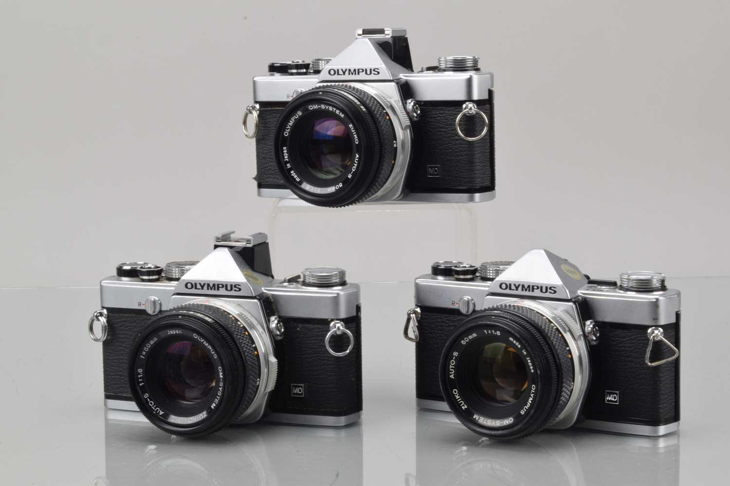 Three Olympus OM-1n SLR Cameras,