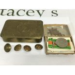 A Princess Mary WW1 tin containing badges and a me