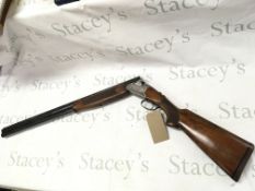A 12 gauge over under shotgun by Lanber. Single tr